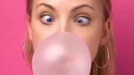 Girl blowing a bubble gum bubble