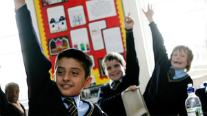 Boys in class with their hands up